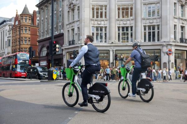 Commuters cycle through Oxford Circus in London