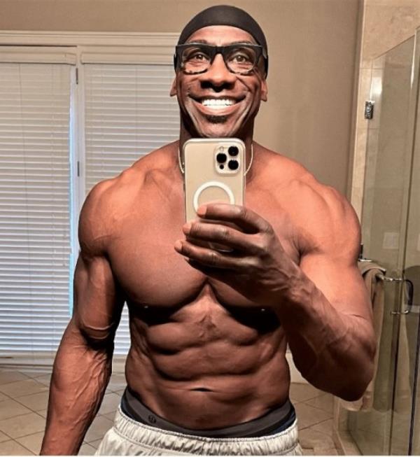 Shannon Sharpe taking a topless selfie