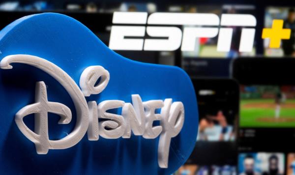 A 3D printed Disney logo is seen in front of the ESPN+ logo