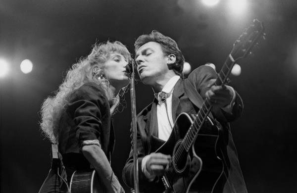 Musician Patti Scialfa and Bruce Springsteen are shown performing on stage during a co<em></em>ncert appearance on February 28, 1988. 